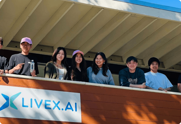 LiveX team members on a balcony near a LiveX.ai sign