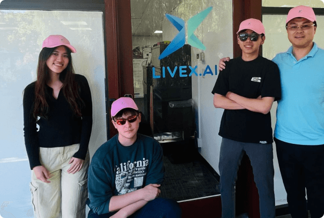 LiveX team members posing by a LiveX.ai office door